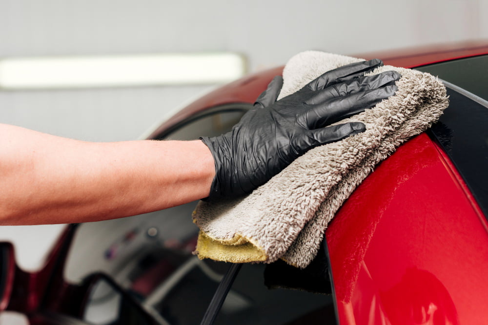 close up person cleaning car exterior 1